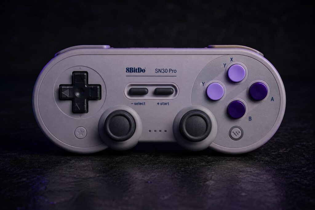 Divoom Pixoo-64 showing pixel art on a retro gaming shelf